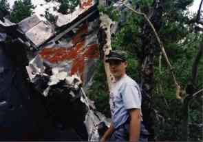 Thomas standing by X marked tail