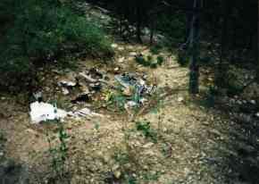 debris scattered in raw earth closed trench